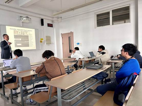 A group of people sitting in a classroomDescription automatically generated